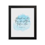 Serene Bible verse wall art with Psalm 2:12 and soft blue watercolor design, perfect for peaceful home decor. Wall Art hung on the wall in a black frame