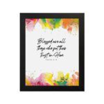 Vibrant Bible wall art with Psalm 2:12 verse and colorful paint splash in green, yellow, pink, and orange. Wall Art hung on the wall in a black frame