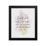 Psalm 18:3 Bible Wall Art with a soft pastel background and light green and beige leaves, featuring dark, elegant text. Wall Art hung on the wall in black frame