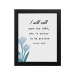 I Will Call Upon The Lord Psalm 18:3 Bible Verse Wall Art with black text on a light background and a soft blue flower in the bottom left corner. Wall Art hung on the wall in a black frame