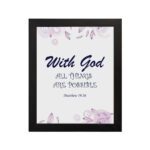 With God All Things Are Possible Matthew 19:26 Bible Verse Wall Art with purple text and light purple floral accents on a white background. Wall Art hung on the wall in black frame