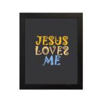 Infidu Jesus Loves Me Bible Wall Art with dark background and decorative yellow, gold, and blue text hung on the wall in a black frame