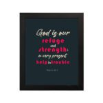 Infidu Psalm 46:1 Bible Wall Art with a deep blue background, pink and white text, featuring God is our refuge and strength. Wall Art hung on the wall in a black frame