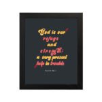 Psalm 46:1 Bible Wall Art with bold, colorful text on a deep black background. Wall Art hung on the wall in a black frame