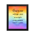 Psalm 46:1 Bible Wall Art with black vertical text on a vibrant rainbow gradient background. Wall Art hung on the wall in a black frame