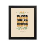 Psalm 50:15 Bible Wall Art with bold black, orange, and yellow text and simple floral embellishments on a cream background. Wall Art hung on the wall in black frame