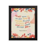 Psalm 50:15 Bible Verse Wall Art with colorful text, floral patterns, bird illustration, and beige background. Wall Art hung on the wall in a black frame