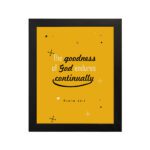 Bright mustard yellow wall art with Psalm 52:1. God in gold and playful font with star-like designs. Wall Art hung on the wall in a black frame