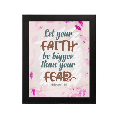 Christian wall art with brown 'Faith' and 'Fear' text, pink leaves, and a light pink floral background. Wall Art hung on the wall in a black frame