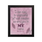 Infidu Jeremiah 18:6 Christian wall art with dark brown cursive text and bold 'MY' in brownish-purple, on a light pink background with leaf patterns. wall art hung on the wall in a black frame