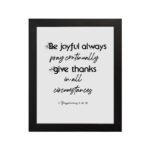 Infidu wall art with the text Be joyful always, pray continually, give thanks in all circumstances from 1 Thessalonians 5:16-18. hung on the wall in a black frame