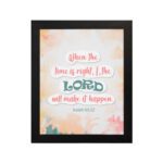 Infidu Isaiah 60:22 Christian wall art with coral and teal text, teal LORD, and a soft pastel watercolor background with floral shapes. Wall Art hung on the wall in a black frame