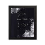 Be Still and Know That I Am God Psalm 46:10 Christian wall art with handwritten text on a navy blue background. wall art hung on the wall in a black frame