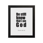 Be Still and Know That I Am God Psalm 46:10 Bible Verse Wall Art with bold black text on a white background. Wall Art hung on the wall in black frame