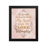 Zechariah 4:6 Christian wall art featuring Not By Might Nor By Power in gold script on a light peach background with floral accents. Wall Art hung on the wall in a black frame