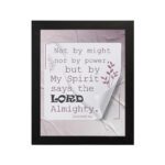 Zechariah 4:6 Bible verse wall art with soft purple text, bold LORD, decorative plant motif, and light purple folded paper background. hung on the wall in a black frame