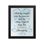 Zechariah 4:6 Bible verse wall art with light blue and white text, decorative flourishes, and a light blue gradient background. Inspiring Christian home decor. Wall Art hung on the wall in a black frame