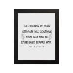 Bible verse wall art with Psalm 102:28 in black text on a white background, featuring decorative leaf designs for an elegant touch. hung on the wall in a black frame