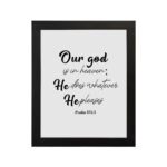 Bible verse wall art with Psalm 115:3 in black text on a white background. Modern design with cursive and standard fonts. hung on the wall in a black frame