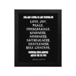 Galatians 5:22-23 Bible Verse Wall Art with White Text on Black Background hung on the wall in a black frame