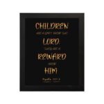 Bible wall art featuring the verse 'Children are a gift from the LORD' in golden text on a black background. hung on the wall in a black frame