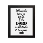 Infidu wall art displaying When the time is right, I, the LORD will make it happen in black text on a white background. hung on the wall in a black frame