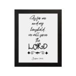 Joshua 24:15 Bible wall art with black text on a white background, framed in black, reading As for me and my household. hung on the wall in a black frame