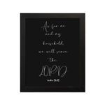 Joshua 24:15 Bible wall art with white cursive text on a black background, emphasizing LORD in a modern design. hung on the wall in a black frame