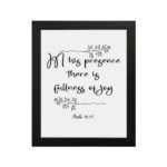 In His Presence There Is Fullness of Joy in a black script font with decorative branches and Psalm 16:11 on a white background - Christian wall art. hung on the wall in a black frame