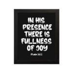 In His Presence There Is Fullness of Joy in bold white block letters with Psalm 16:11 on black background hung on the wall in a black frame - Christian wall art.