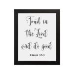 Trust In The Lord And Do Good Psalm 37:3 black cursive text on white background Christian wall art hung on the wall in a black frame