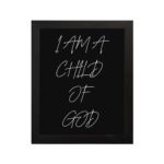 I Am A Child Of God Bible wall art with white handwritten text on a black background Wall Art hung on the wall in a black frame