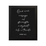 Psalm 46:1 Bible wall art with white text on black background, saying 'God is our refuge and strength, a very present help in trouble. Wall Art hung on the wall in a black frame