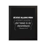 Christian wall art with bold white text on a black background reading Rejoice always, pray without ceasing, give thanks from 1 Thessalonians 5:16-17. hung on the wall in a black frame