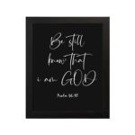 Be Still and Know That I Am God - Psalm 46:10 Bible Verse Wall Art with White Cursive Text on Black Background Wall Art hung on the wall in a black frame