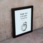 Keep Me As The Apple Of Your Eye Psalm 17:8 Bible Verse Wall Art with light blue background and simple apple sketch. Wall Art displayed on the wall in a black frame