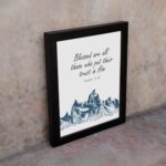 Psalm 2:12 Bible Verse Wall Art with deep blue mountain range design. Wall Art displayed on the wall in a black frame