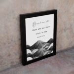 Psalm 2:12 Bible wall art featuring a black-and-white mountain landscape with the verse Blessed are all those who put their trust in Him. Wall Art displayed on the wall in black frame