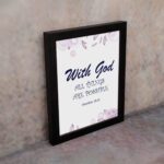 With God All Things Are Possible Matthew 19:26 Bible Verse Wall Art with purple text and light purple floral accents on a white background. Wall Art displayed on the wall in a black frame