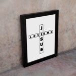 Infidu Jesus Loves Me Bible Wall Art with the crossword-style layout in black text on a white background Wall Art displayed on the wall in black frame