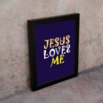 Infidu Jesus Loves Me Bible Wall Art with deep purple background and yellow decorative lettering Wall Art displayed on the wall in a black frame