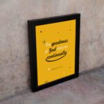 Bright mustard yellow wall art with Psalm 52:1. God in gold and playful font with star-like designs. Wall Art displayed on the wall in a black frame