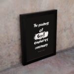 Infidu The Goodness Of God Endures Continually Psalm 52:1 Christian wall art with bold white text on a black background. Wall Art displayed on the wall in a black frame