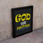 God Will Provide Christian wall art with bold yellow text and a dark black background, perfect for home decor. Wall Art displayed on the wall in a black frame