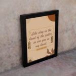 Infidu Jeremiah 18:6 Christian wall art with cursive brown text on a beige background, flanked by wheat stalks and pottery silhouettes. Wall Art displayed on the wall in a black frame