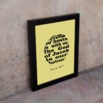 Infidu The Lord Of Hosts Is With Us Psalm 46:7 Bible Verse Wall Art on light yellow background. displayed on the wall in a black frame