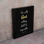 Luke 1:37 Bible verse wall art with black background, yellow highlights on God and Impossible. Christian home decor by Infidu. Wall Art on the wall in a black frame