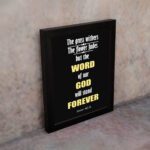 Infidu The Grass Withers The Flower Fades But The Word Of Our God Will Stand Forever Isaiah 40:8 Bible Wall Art and black frame on the wall