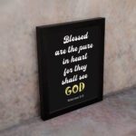 Bible verse wall art with black background, yellow and white font, featuring Matthew 5:8 verse black frame on the wall