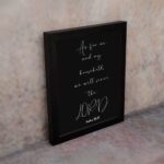 Joshua 24:15 Bible wall art with white cursive text on a black background, emphasizing LORD in a modern design. displayed on the wall in a black frame